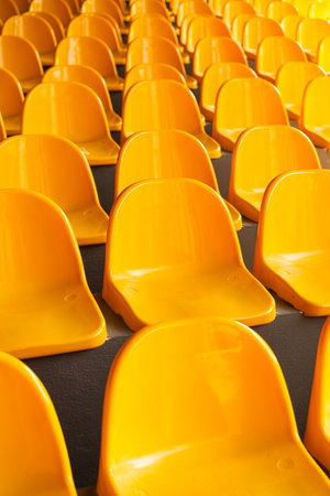 Plenty of yellow plastic seats at stadium.の写真素材