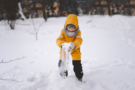 A joyful child playing in fresh snow during winters frosty embrace