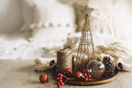 Festive holiday decor arrangement featuring a miniature Christmas tree and cozy winter elementsの写真素材