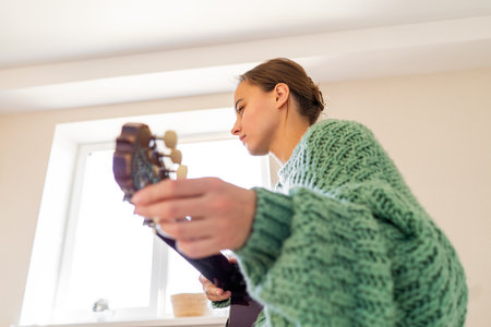 A woman playing a guitarの写真素材