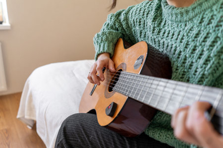 A woman playing a guitarの写真素材