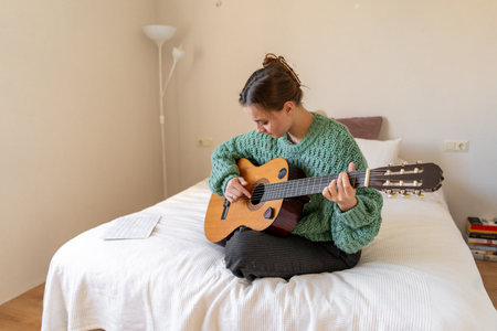A woman playing a guitarの写真素材