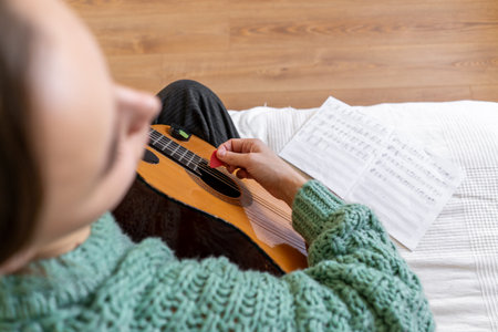 A woman playing a guitarの写真素材