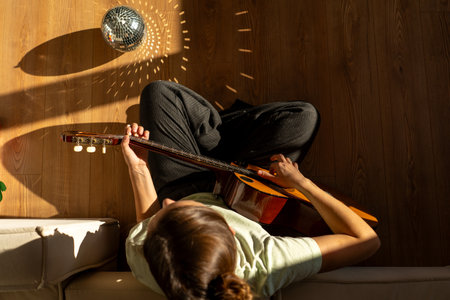 A woman playing a guitarの写真素材