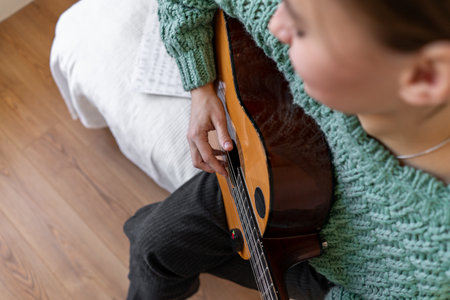 A woman playing a guitarの写真素材