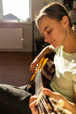 A woman playing a guitarの写真素材