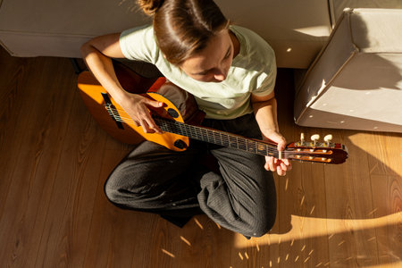 A woman playing a guitarの写真素材