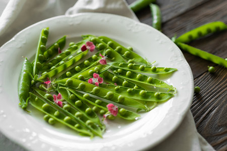 Fresh green peas on a wooden background.の写真素材