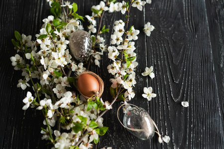 Spring cherry blossoms and Easter eggs on old wooden background.の写真素材