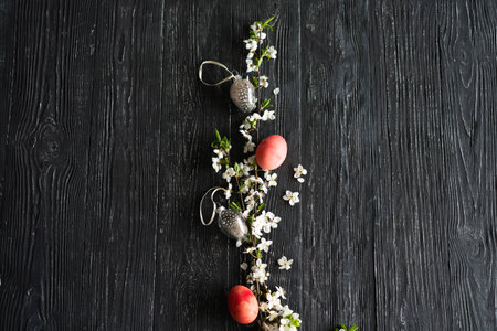 Spring cherry blossoms and Easter eggs on old wooden background.の写真素材