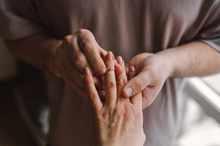 The man made an offer of his hand and heart to the girl. Romantic gesture.の写真素材