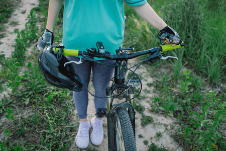 Close Up Of A Black Mountain Bike With A Helmet In The Foregroundの写真素材