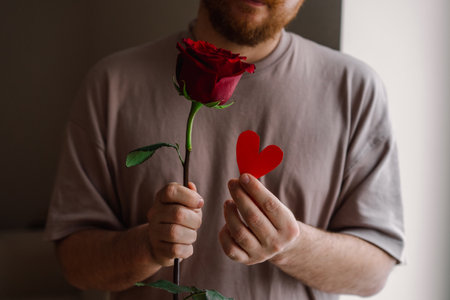 Man holding a red rose expressing love.の写真素材