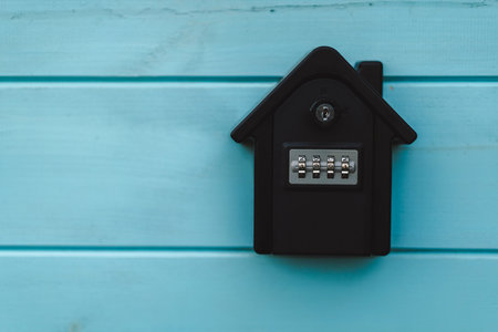 Combination lockbox mounted on a blue wooden wall