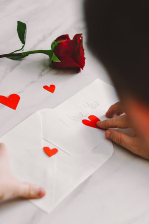 Happy Valentines Day and romantic gesture. A man writes a valentine.の写真素材