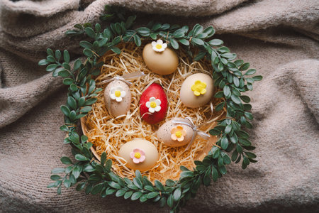 Easter decoration featuring colorful eggs arranged in a cozy nestの写真素材