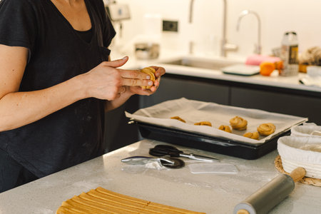Woman prepares dough for bakingの写真素材