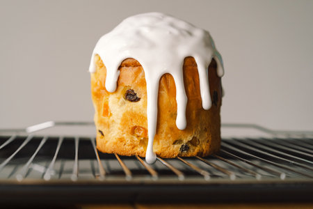 Baking a festive easter panettone with icing on a kitchen countertop during springtime preparationsの写真素材