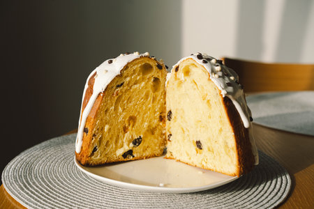 Baking a festive easter panettone with icing on a kitchen countertop during springtime preparationsの写真素材