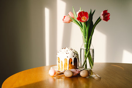 Happy Easter. Stylish easter cake, eggs on a table with spring flowers.の写真素材
