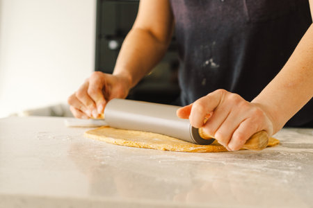 Woman prepares dough for bakingの写真素材