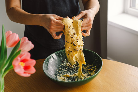 Woman prepares dough for bakingの写真素材