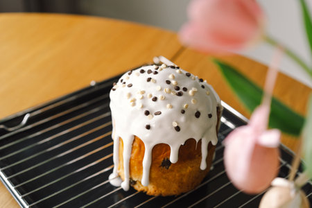 Baking a festive easter panettone with icing on a kitchen countertop during springtime preparationsの写真素材