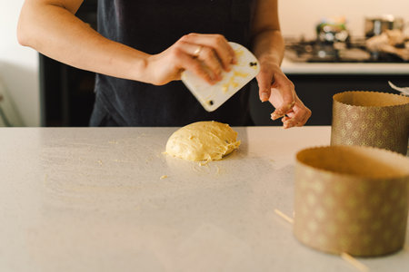 Woman prepares dough for bakingの写真素材