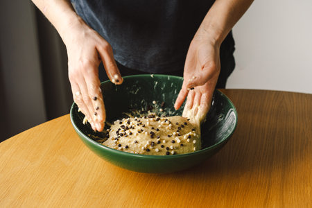 Woman prepares dough for bakingの写真素材