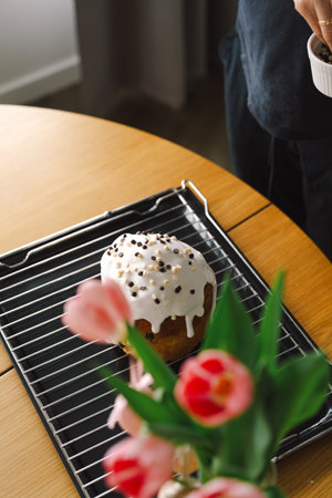 Baking a festive easter panettone with icing on a kitchen countertop during springtime preparationsの写真素材