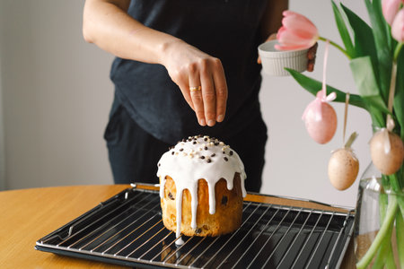 Baking a festive easter panettone with icing on a kitchen countertop during springtime preparationsの写真素材
