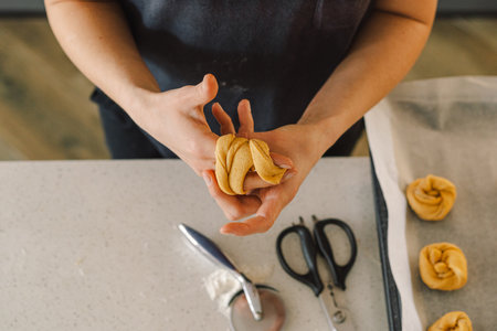 Woman prepares dough for bakingの写真素材
