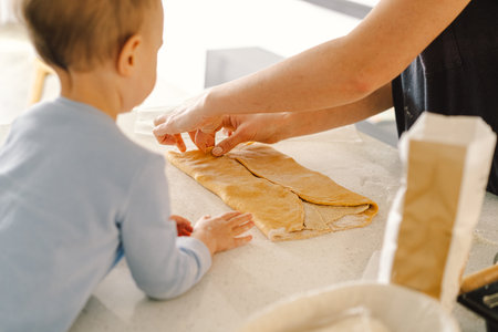 Mother and child are baking. Homemade food and little helperの写真素材