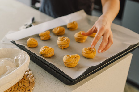 Woman prepares dough for bakingの写真素材