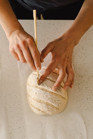 Woman preparing sourdough bread at home