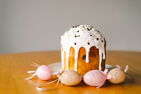 Stylish easter cake, eggs on a table with spring flowers.の写真素材