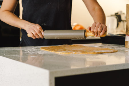 Woman prepares dough for bakingの写真素材