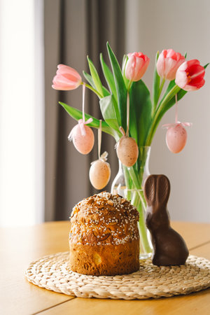 Happy Easter. Stylish easter cake, eggs on a table with spring flowers.の写真素材