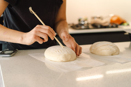Woman preparing sourdough bread at homeの写真素材