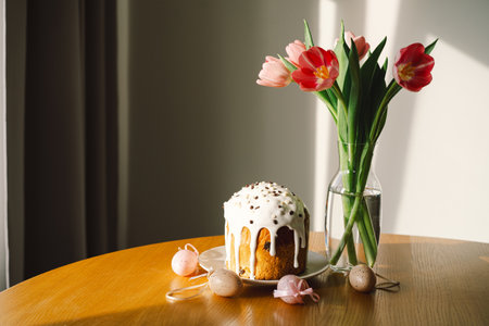 Happy Easter. Stylish easter cake, eggs on a table with spring flowers.の写真素材