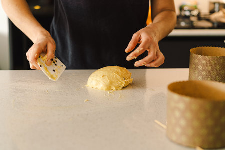 Woman prepares dough for bakingの写真素材