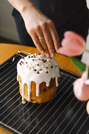 Baking a festive easter panettone with icing on a kitchen countertop during springtime preparationsの写真素材