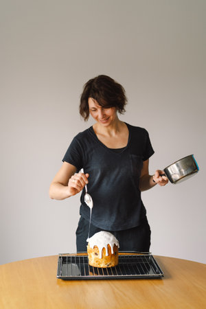 Baking a festive easter panettone with icing on a kitchen countertop during springtime preparationsの写真素材