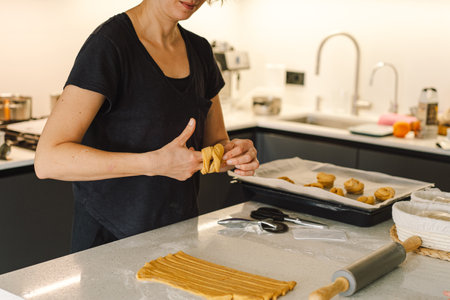 Woman prepares dough for bakingの写真素材