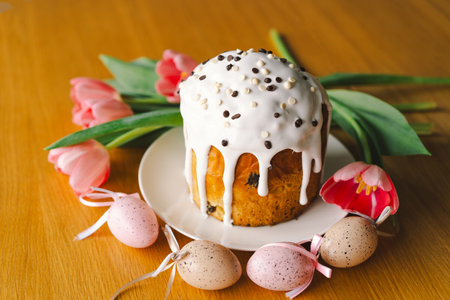 Happy Easter. Stylish easter cake, eggs on a table with spring flowers.