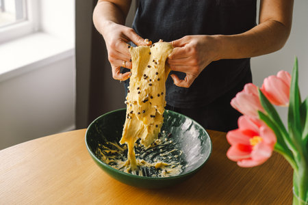 Woman prepares dough for bakingの写真素材