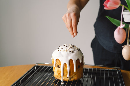 Baking a festive easter panettone with icing on a kitchen countertop during springtime preparationsの写真素材