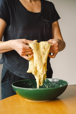 Woman prepares dough for bakingの写真素材