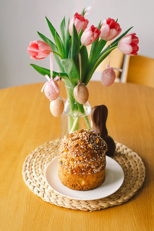 Happy Easter. Stylish easter cake, eggs on a table with spring flowers.の写真素材