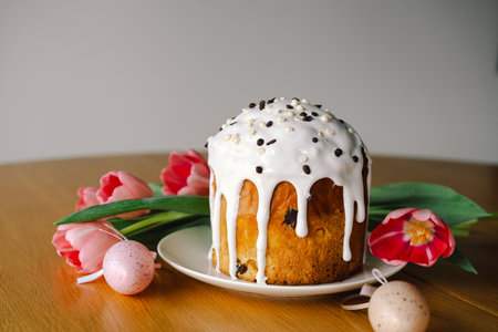 Happy Easter. Stylish easter cake, eggs on a table with spring flowers.の写真素材